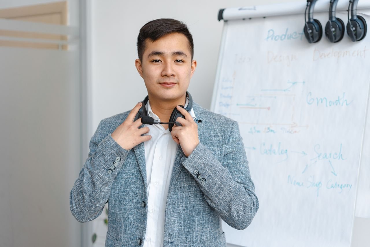 Portrait of a young man with a headset in a modern office environment.